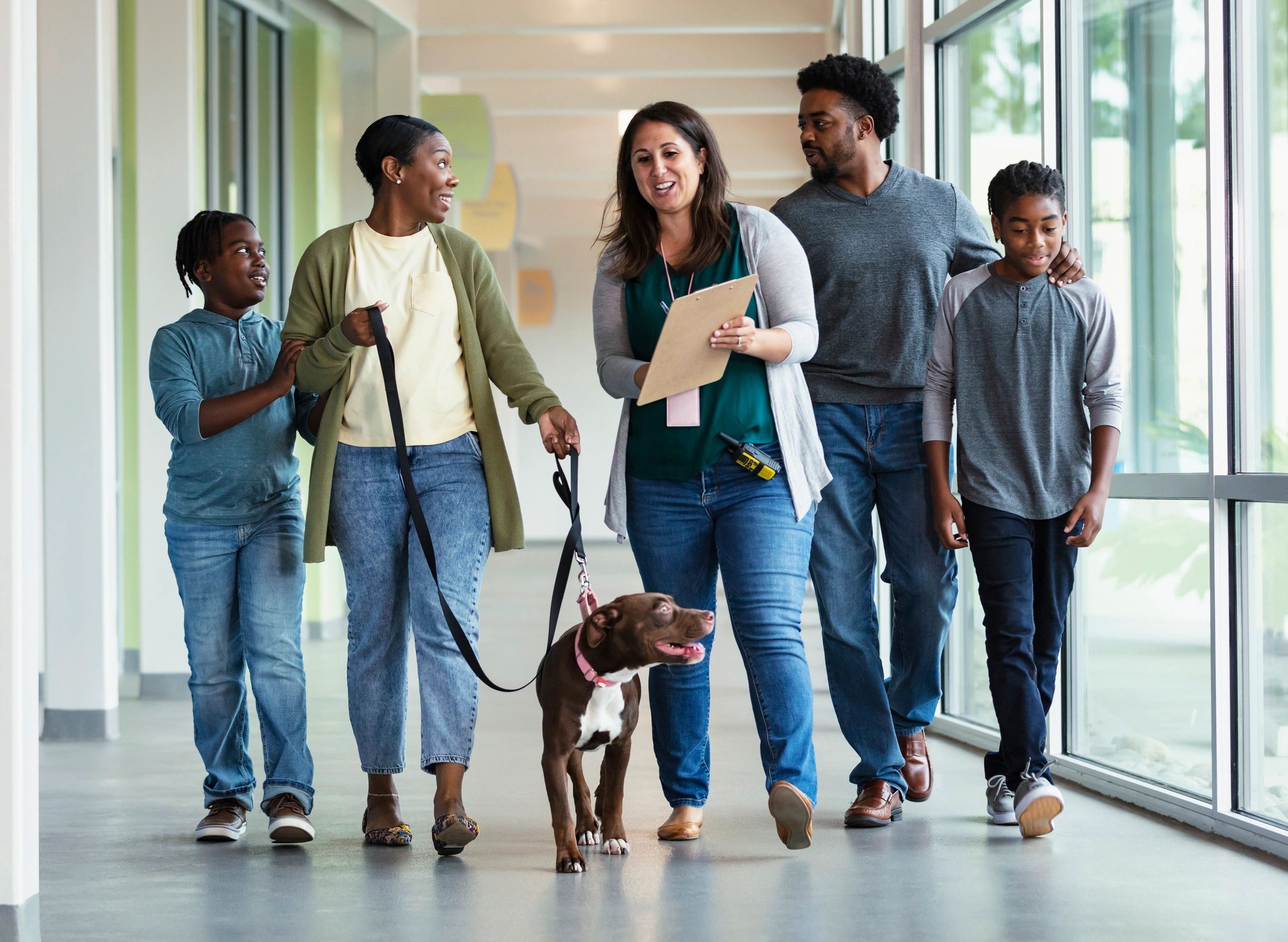 Family adopting a rescue dog with help from a shelter volunteer