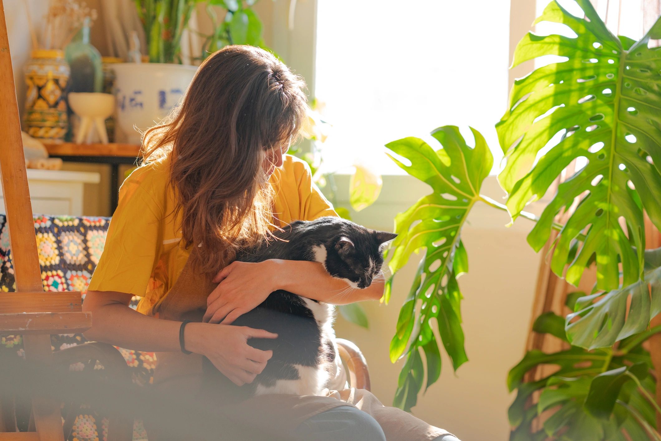Woman embracing her cat in a cozy home